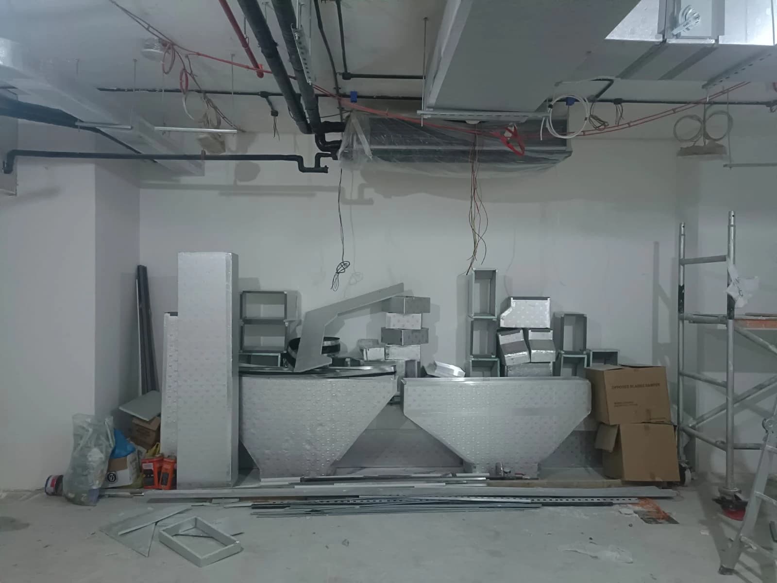AC ductwork components laid out in a commercial space during fit-out