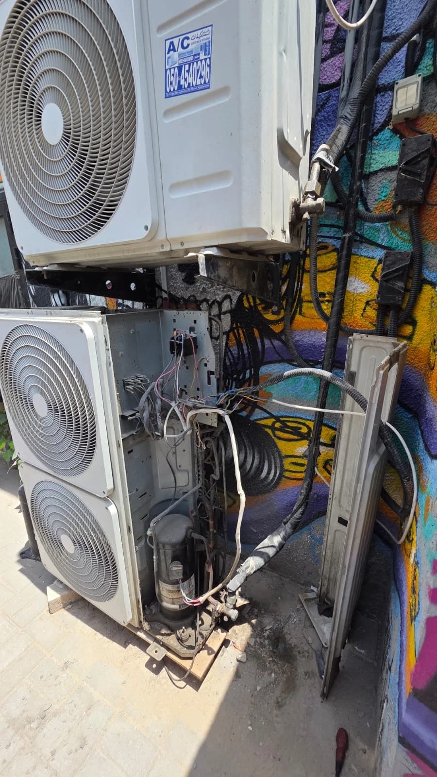 Stacked outdoor AC units opened for service