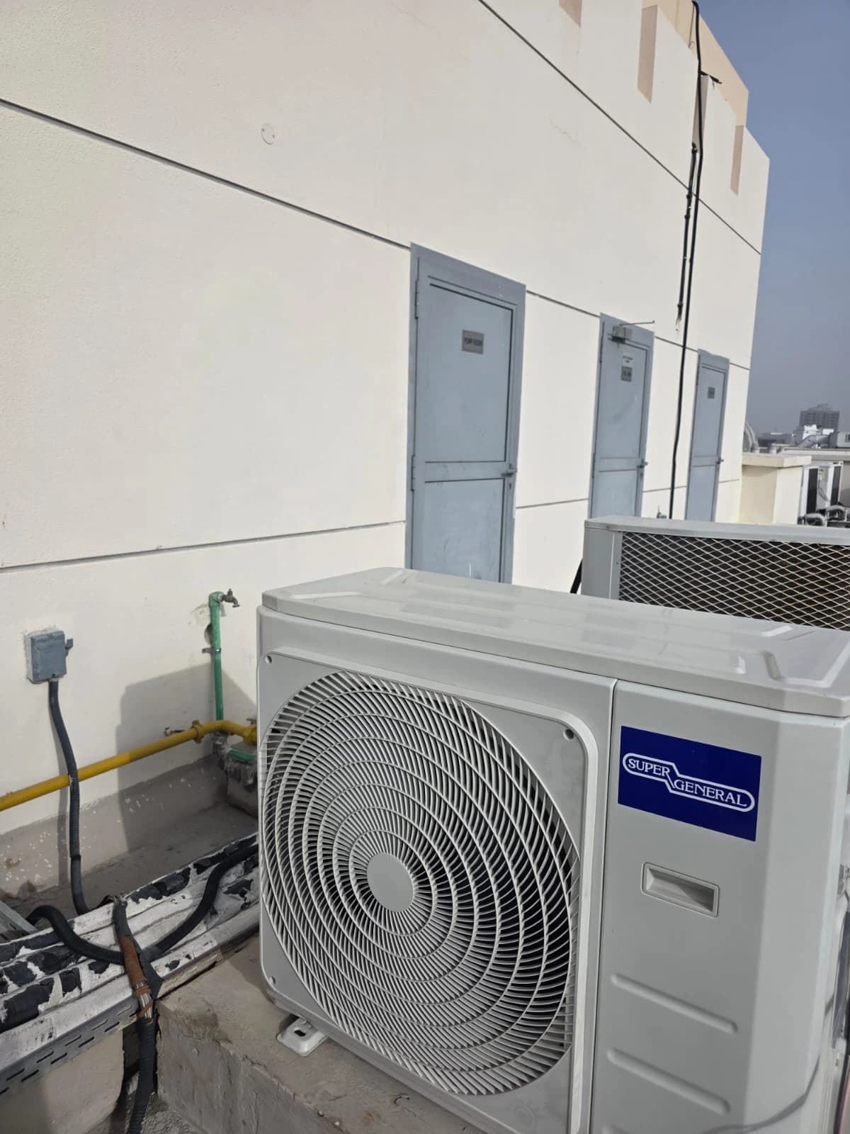 Outdoor AC unit installed on a building rooftop
