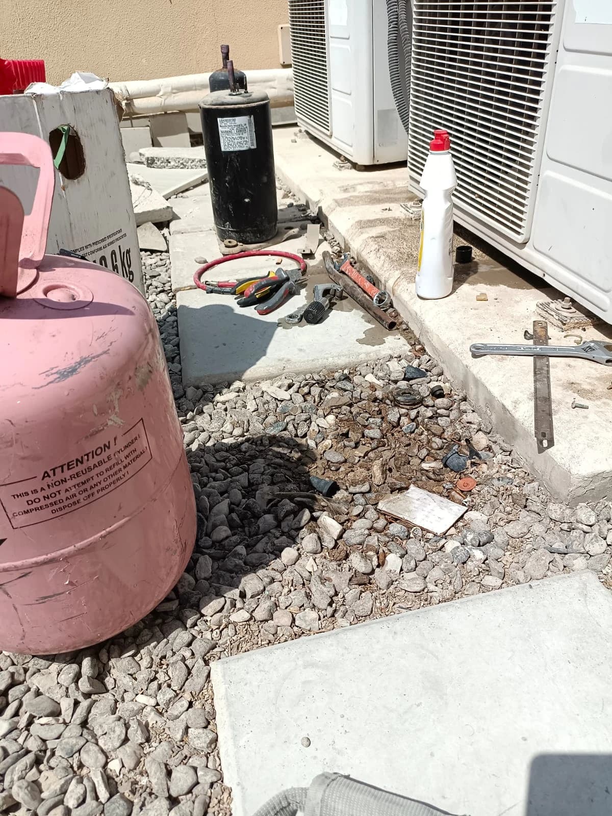 Refrigerant cylinder and replacement compressor beside outdoor AC units
