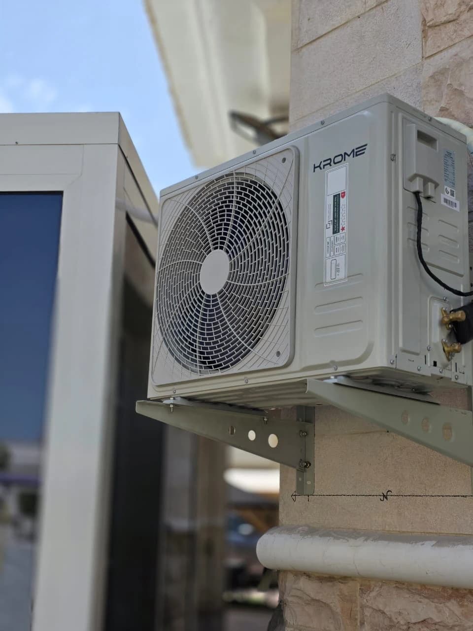 Outdoor AC unit mounted on a wall bracket
