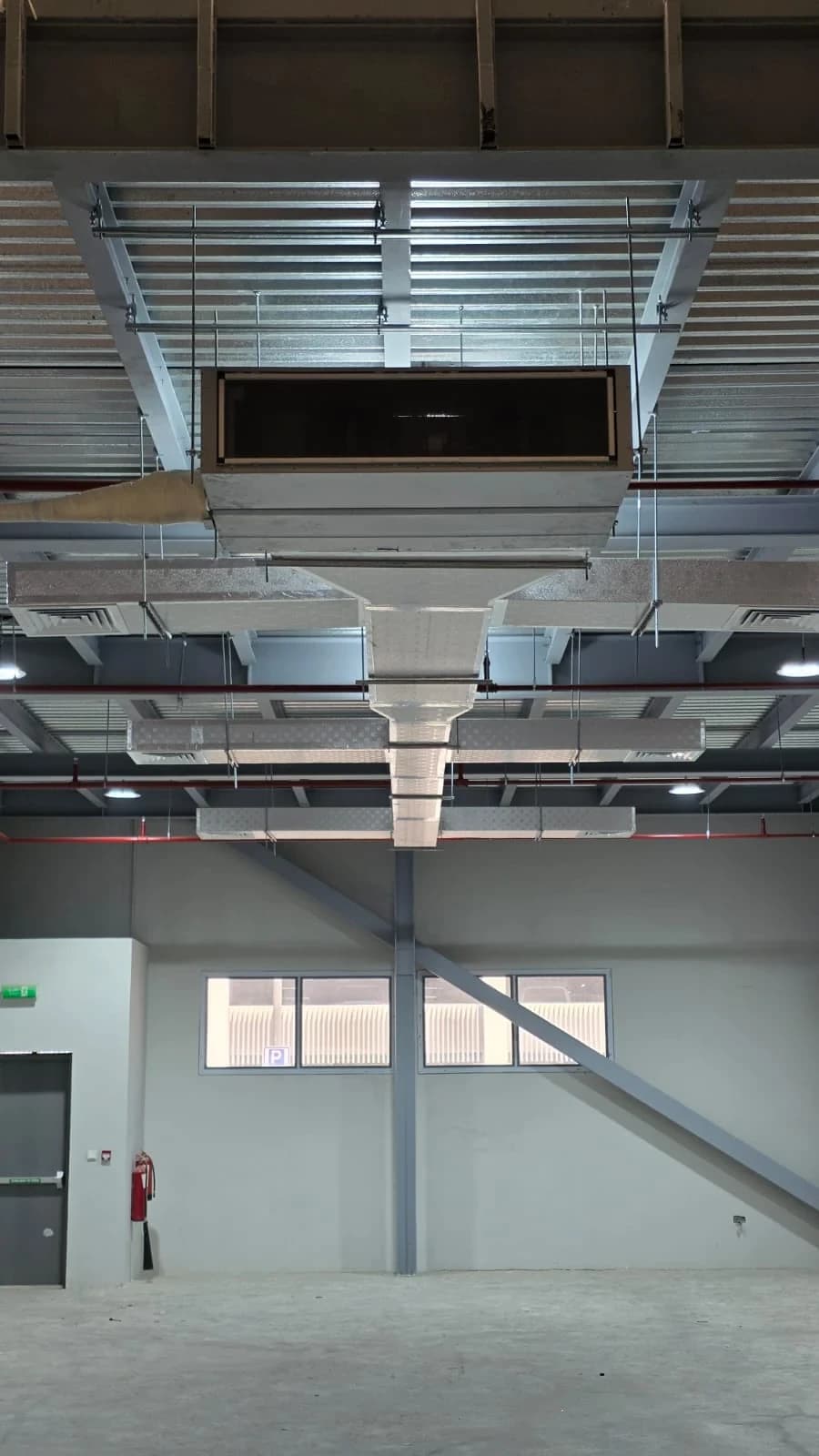 Ducted AC unit installed high in a warehouse