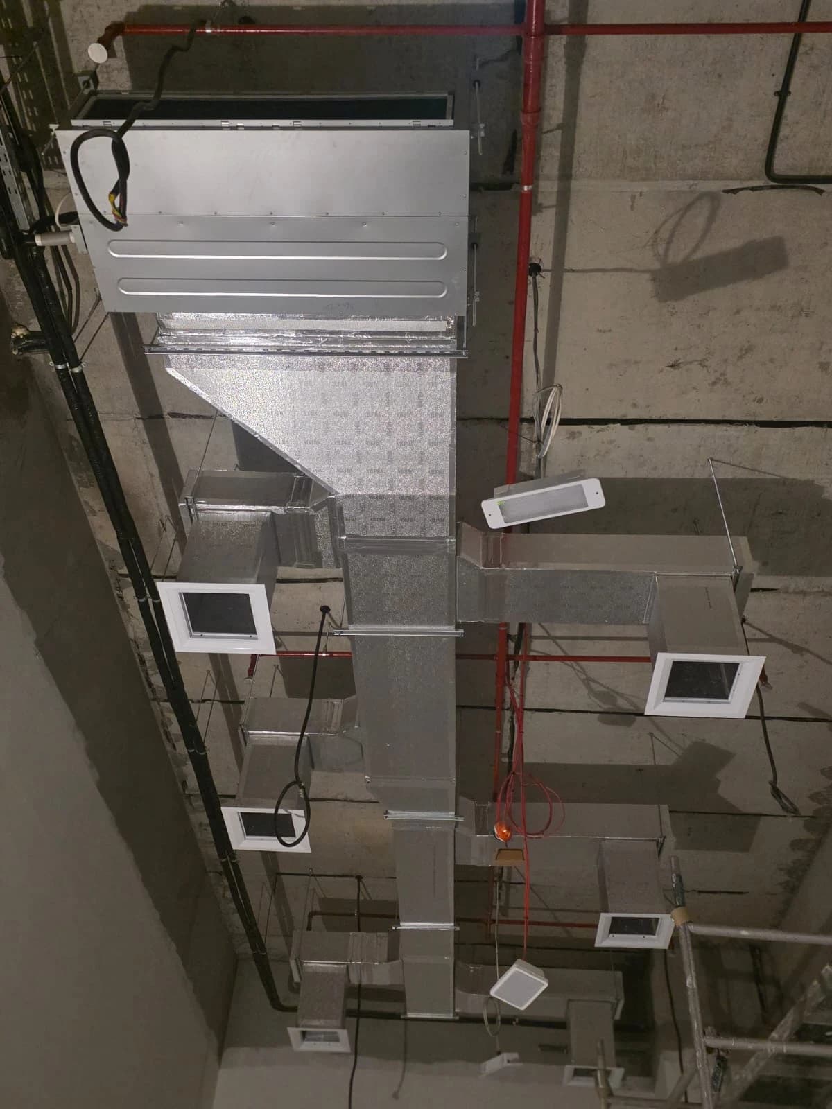 Ducted AC system with supply diffusers installed in an open ceiling